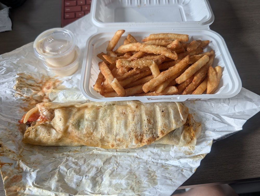 A chicken shawarma wrap with fries and garlic sauce at Shawarma and Grill Box